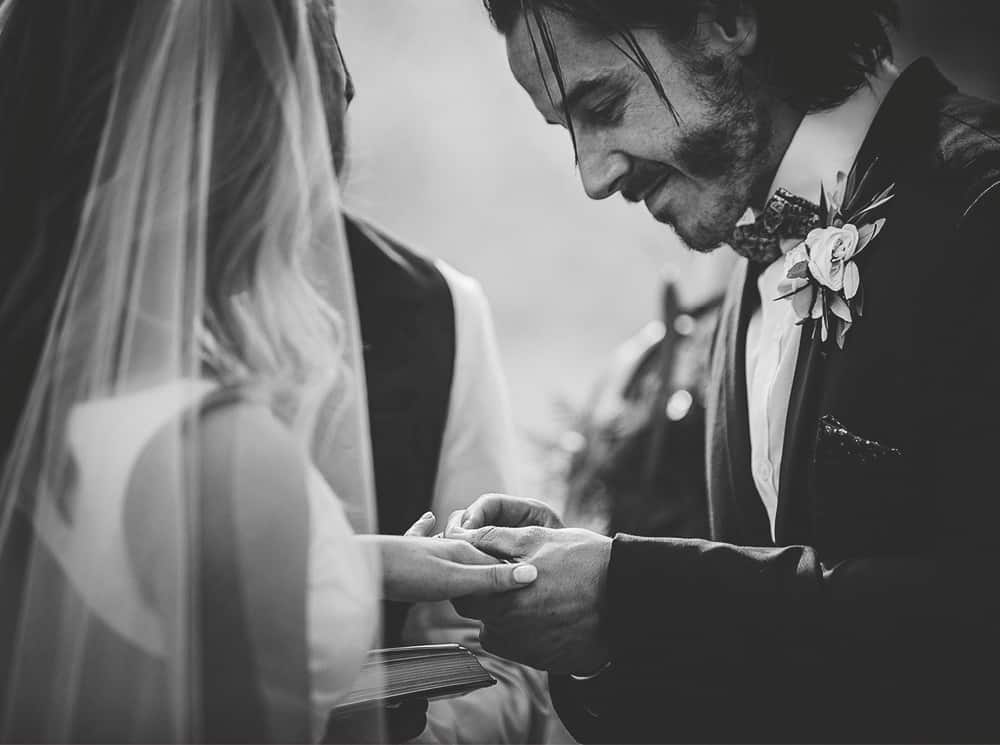 Mansfield Wedding Ceremony - Groom putting ring on Brides finger